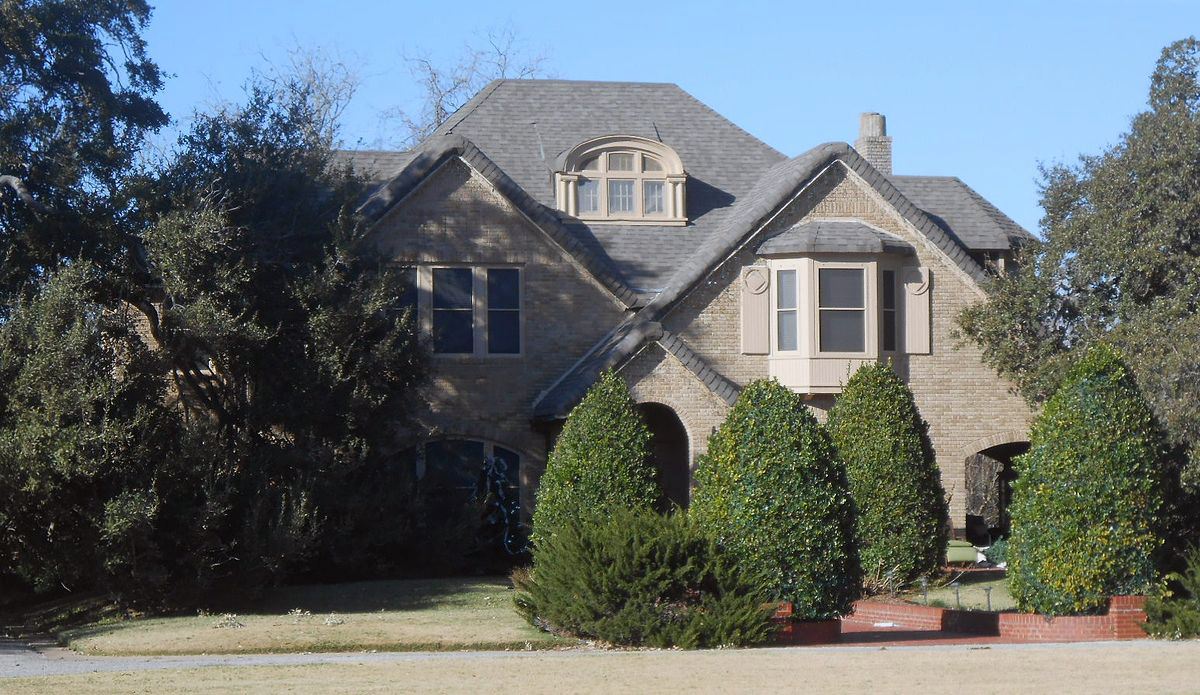 1926, Edward Sweeney House. English Tudor Cotswold Cottage with stately live oaks and circular drive.