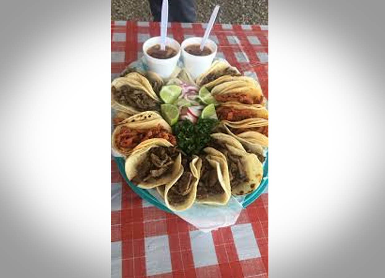 Showing a basket of tacos with salsa.