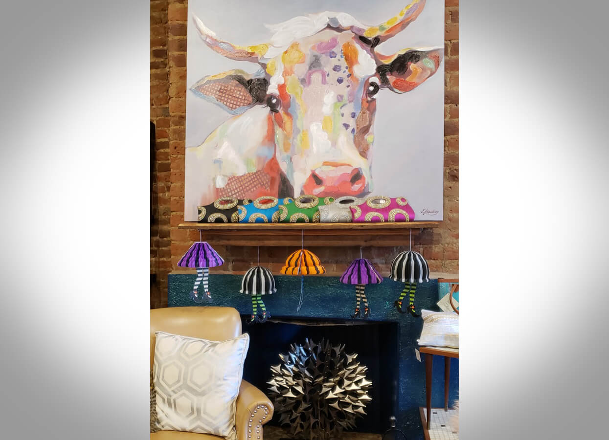 Showing a cow painting for sale at Spaces Sublime.